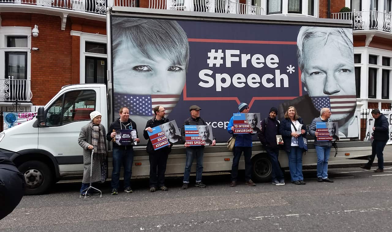 Supporters of Julian Assange hold placards outside of the Ecuadorian Embassy in London earlier this month.