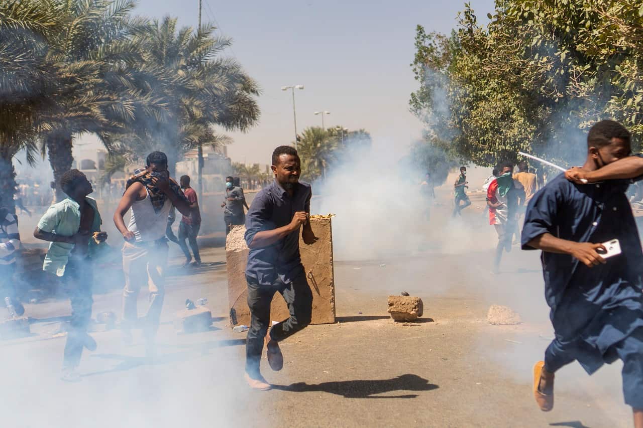 Demonstrators run from tear gas in Khartoum.