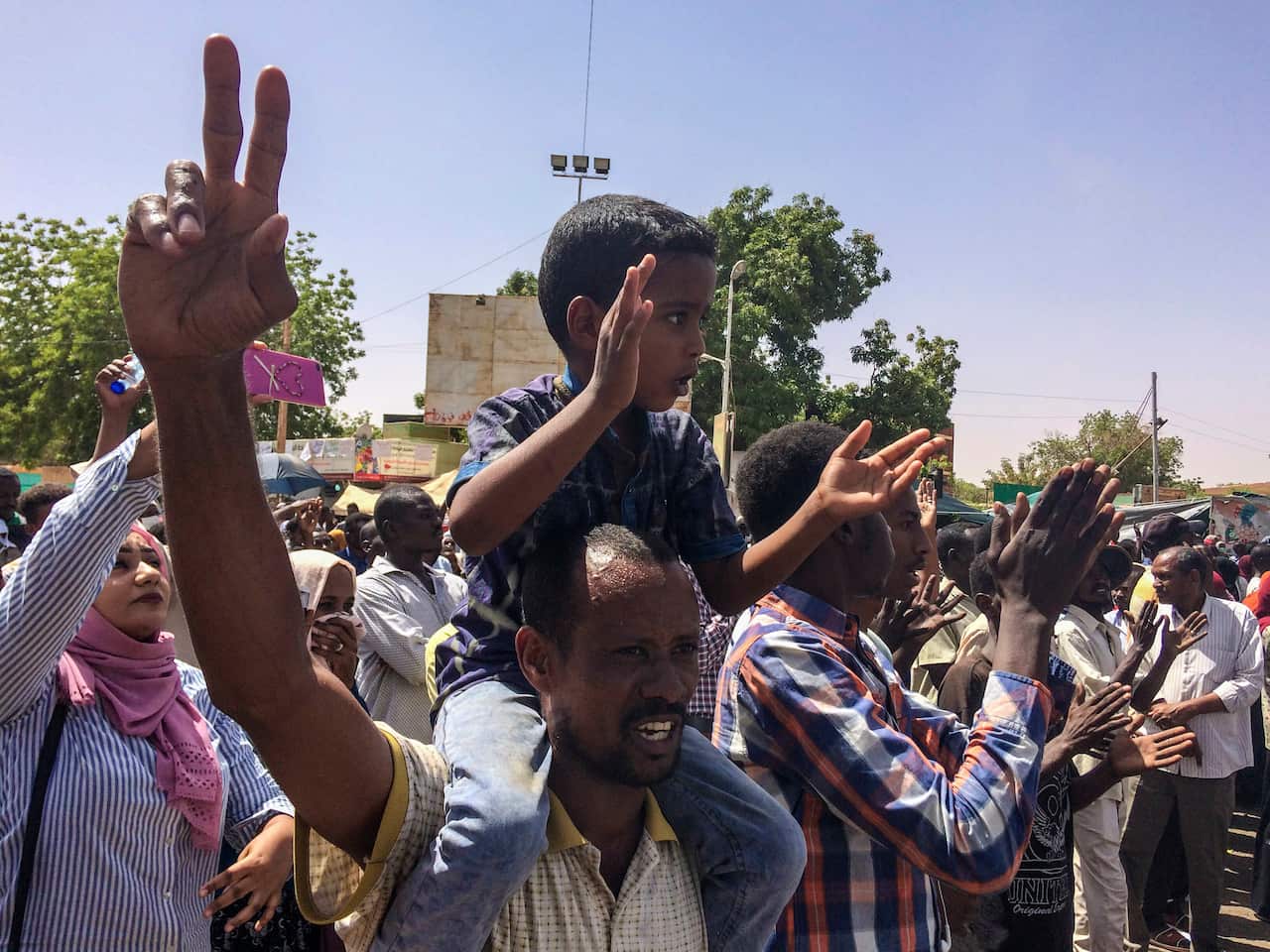 Protesters rally at a demonstration near the military headquarters, Tuesday, April 9, 2019, in the capital Khartoum, Sudan.
