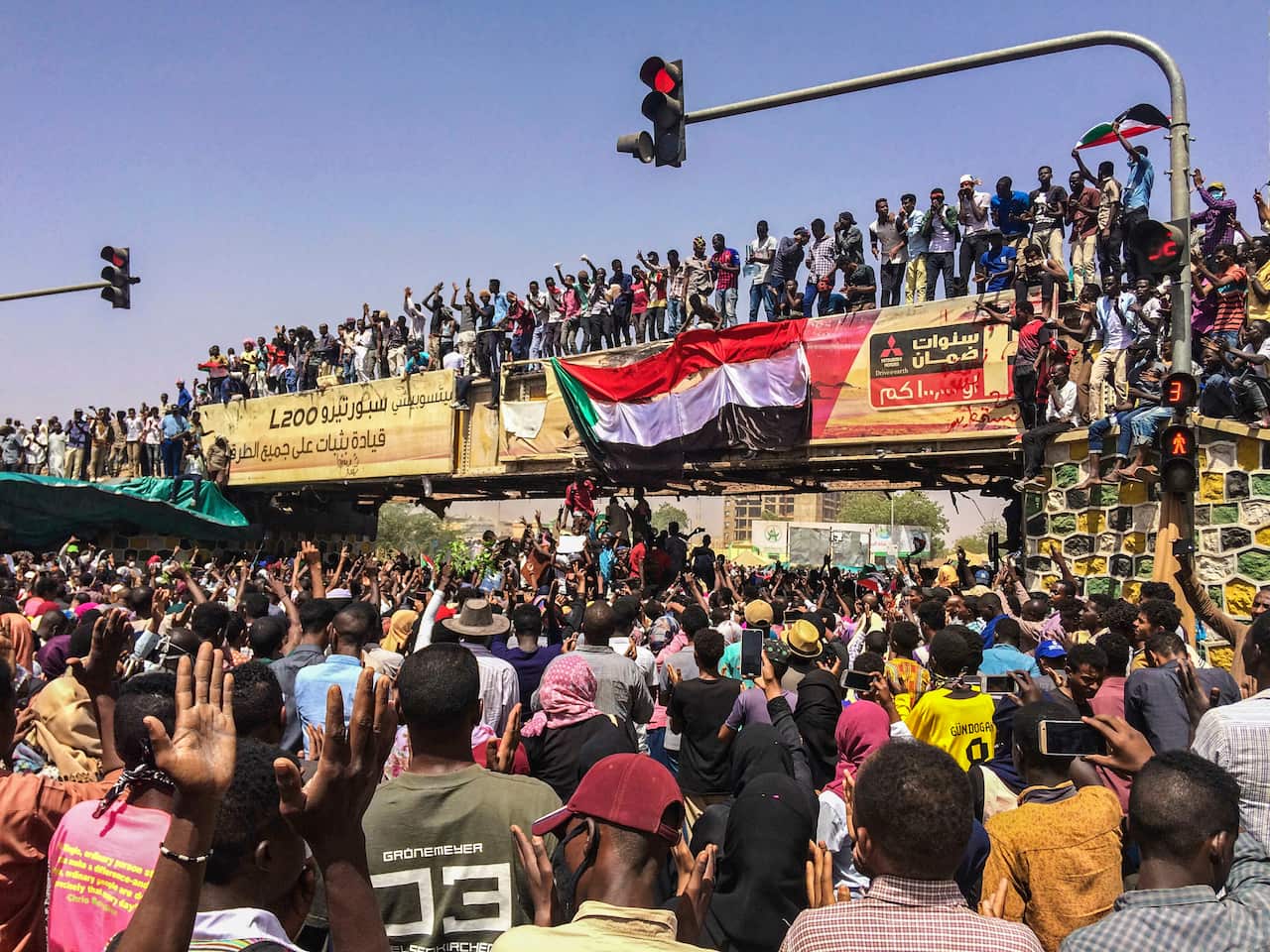 Protesters rally at a demonstration near the military headquarters, Tuesday, April 9, 2019, in the capital Khartoum, Sudan.