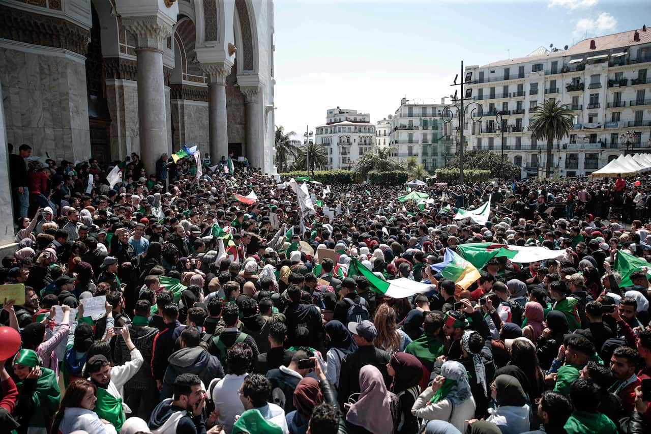 Students wave flags and chant slogans during a demonstration in Algiers, Algeria.