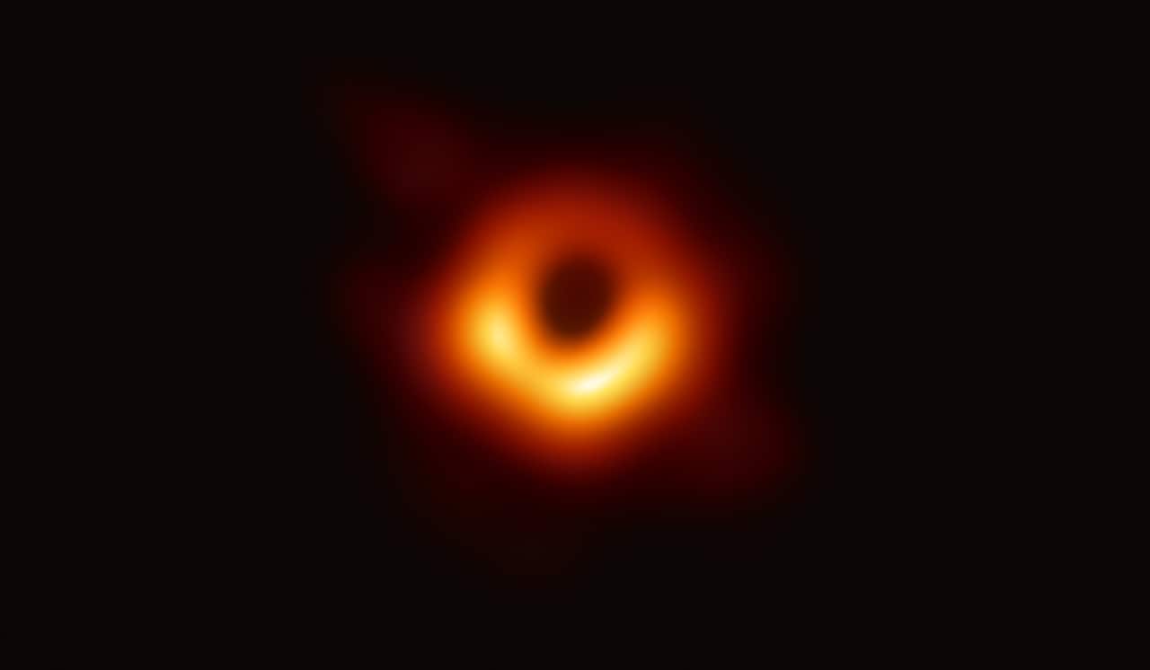 A bright ring formed as light bends in the intense gravity around a black hole that is 6.5 billion times more massive than the Sun. 