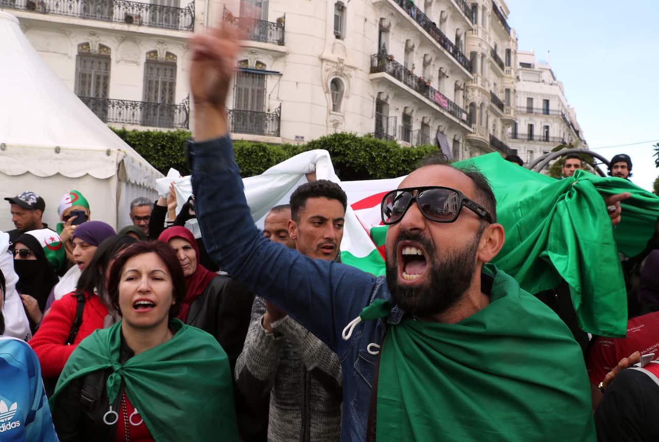 Algerians shout slogans during a protest against interim President Abdelkader Bensalah, in Algiers, Algeria.