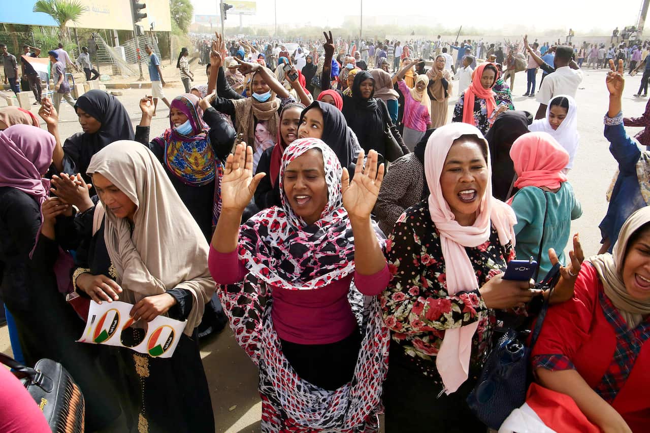 Sudanese people celebrate after state army confirms President Omar al-Bashir has stepped down, in Khartoum, Sudan.