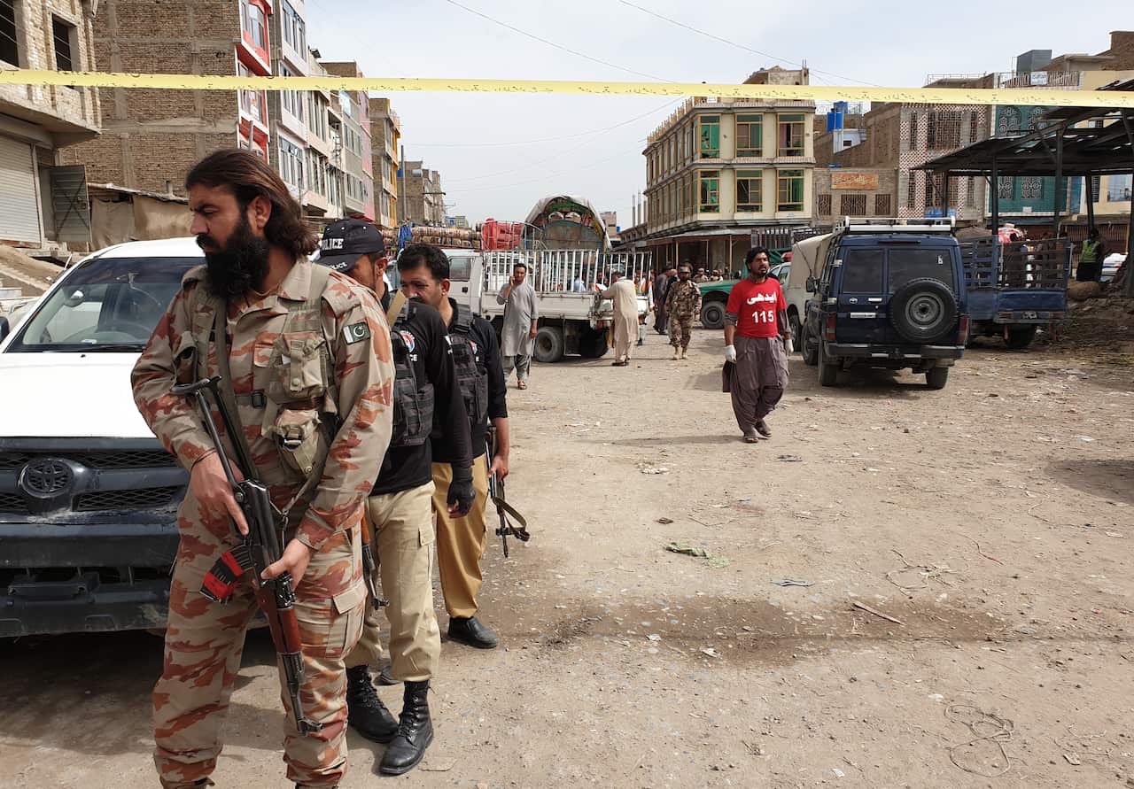 Security officials inspect the scene of a bomb blast in Quetta.