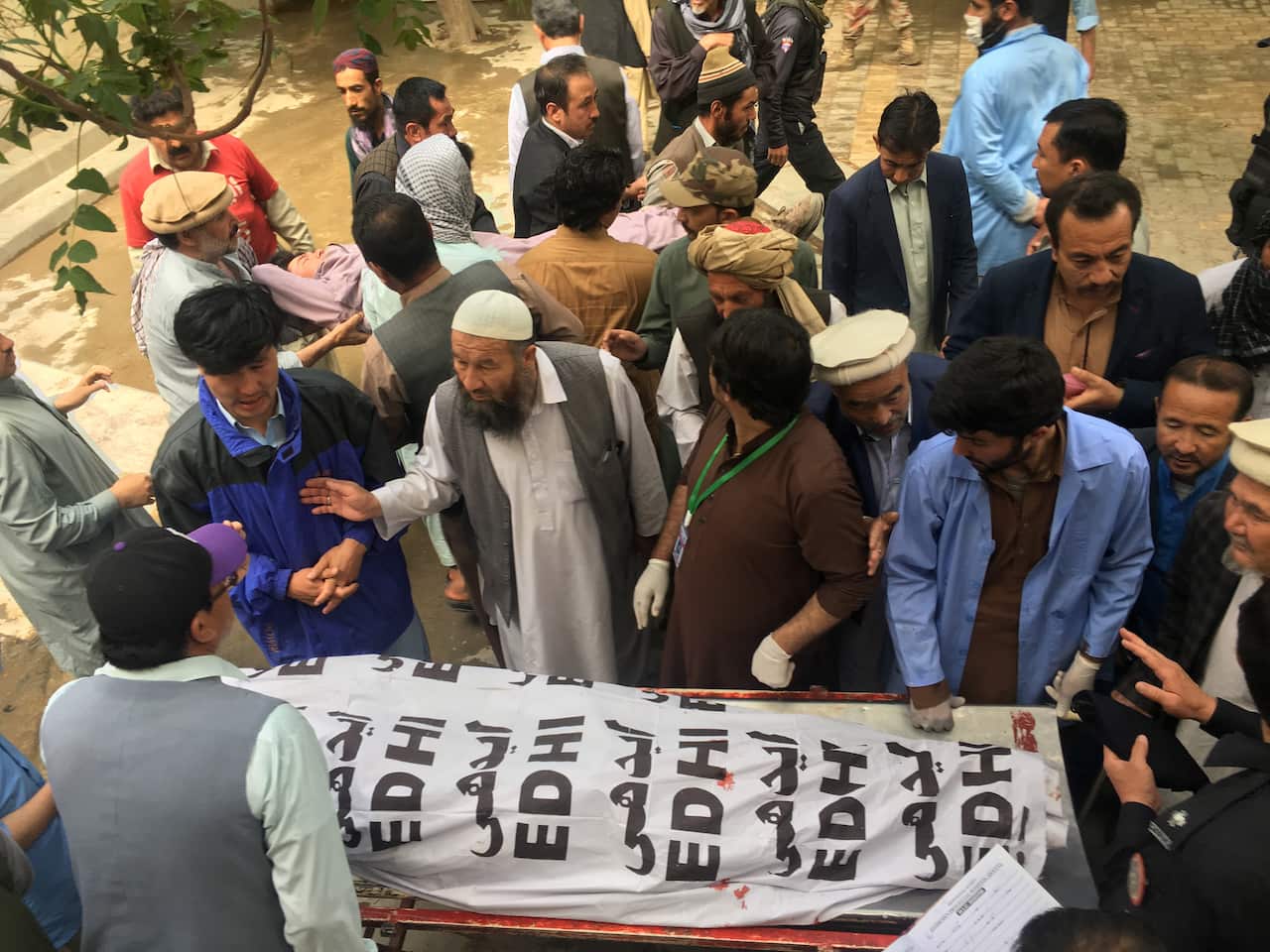 People shift the bodies of the victims of a bomb blast at a mortuary in Quetta, Pakistan.