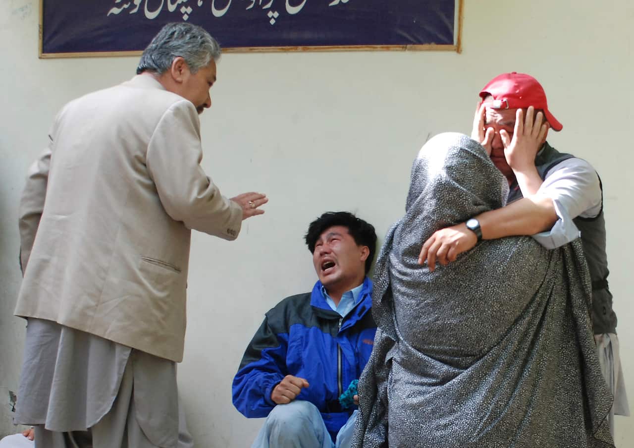 Family members of the blast victims comfort one another. 