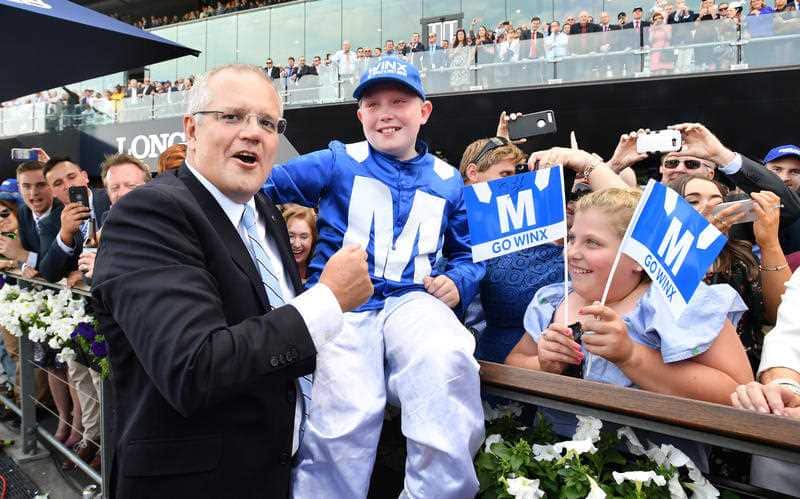 Mr Morrison celebrates with Winx fans after the race.