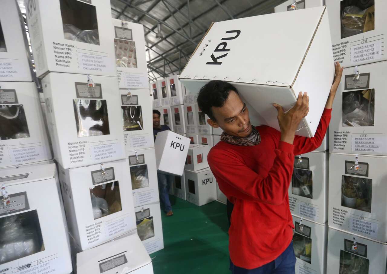 Workers carry ballot boxes to be distributed to polling stations in Jakarta, Indonesia.