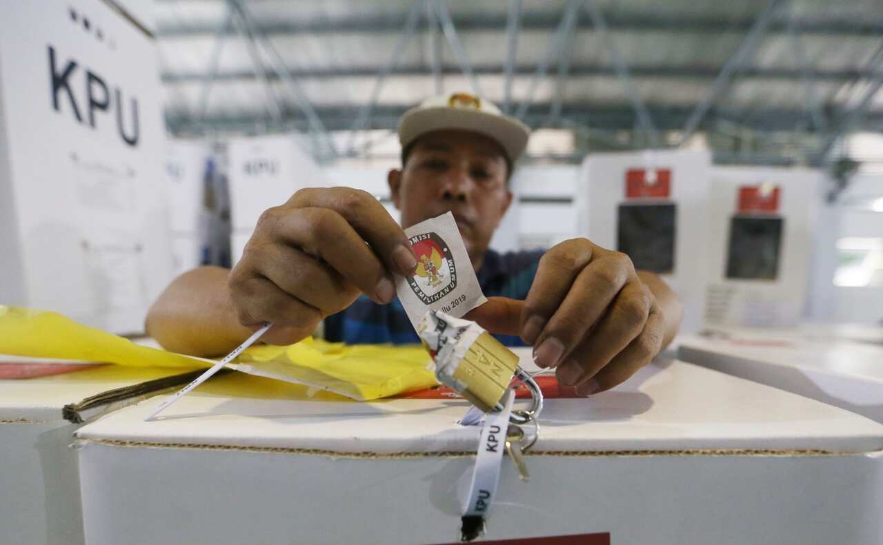 A worker prepares a ballot box to be distributed to polling stations in in Jakarta, Indonesia.