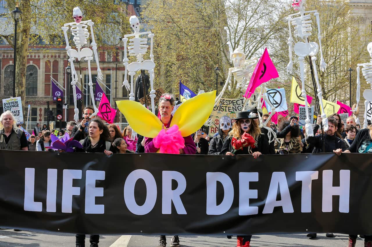 Environmental activists are seen holding a banner that says life or death during the demonstration.