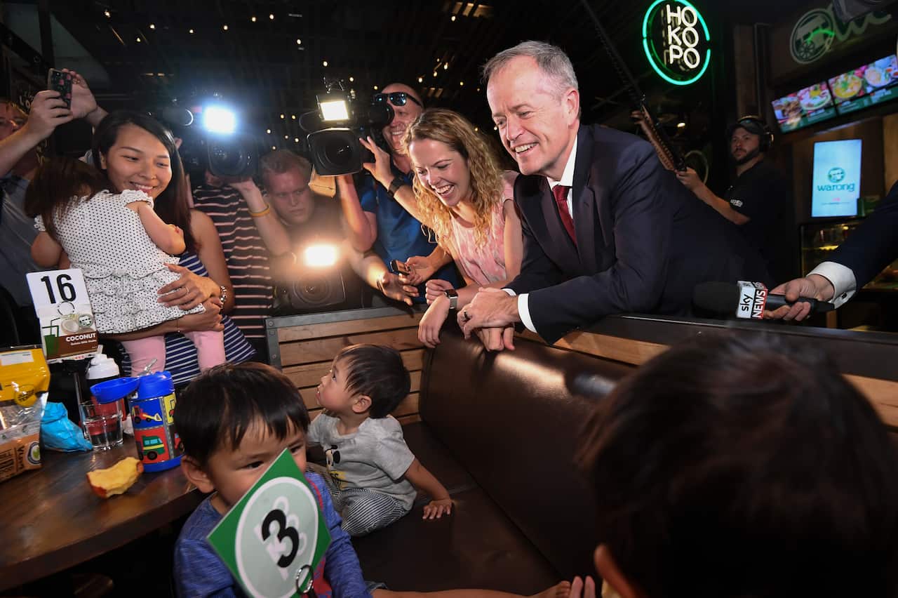 Australian Opposition Leader Bill Shorten and local Labor candidate for Boothby, Nadia Clancy, speak to a family during a street walk at the Westfield Marion shopping centre in Adelaide, April 16, 2019. 