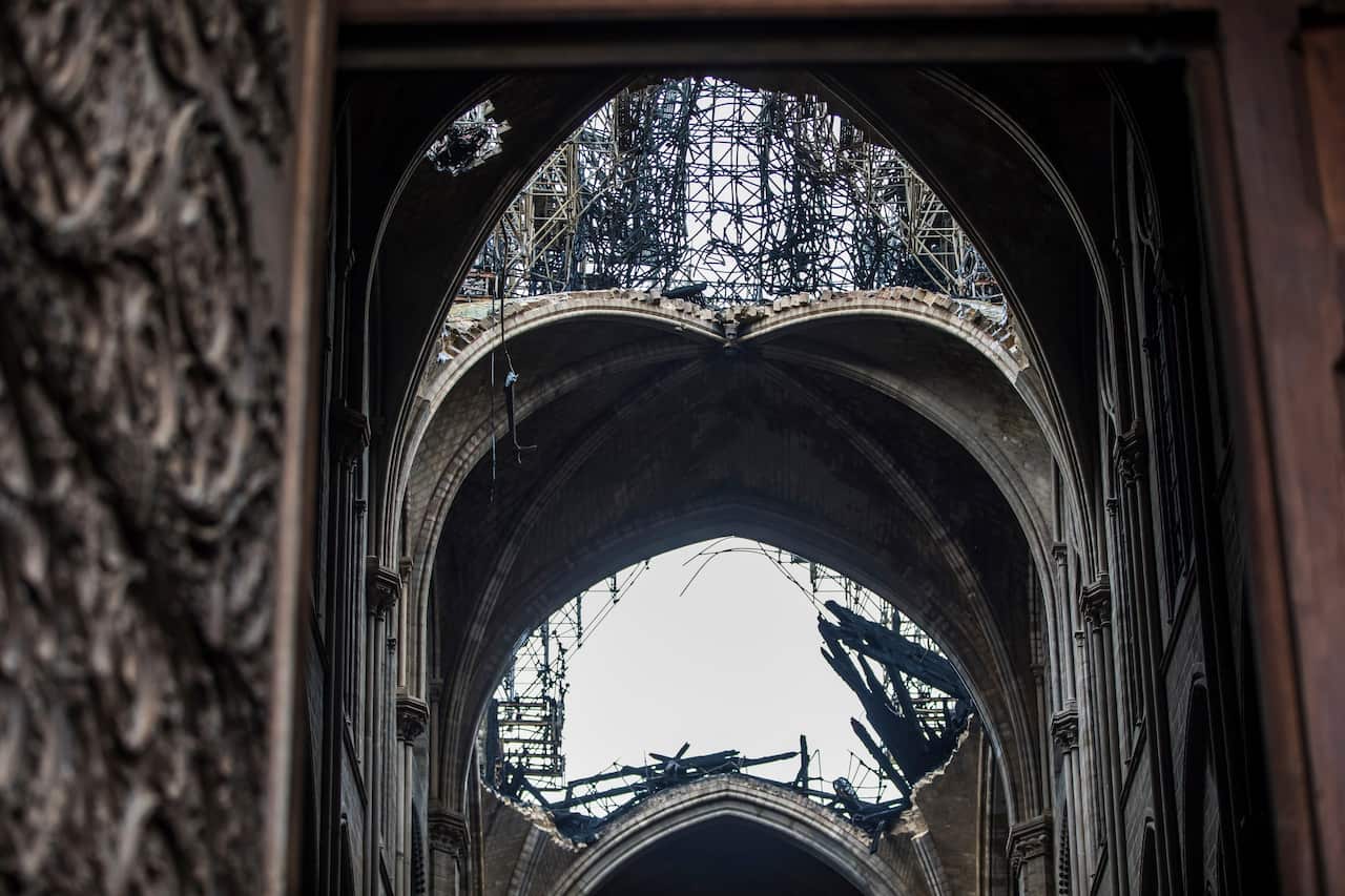 A hole is seen in the dome inside the damaged Notre Dame cathedral in Paris.