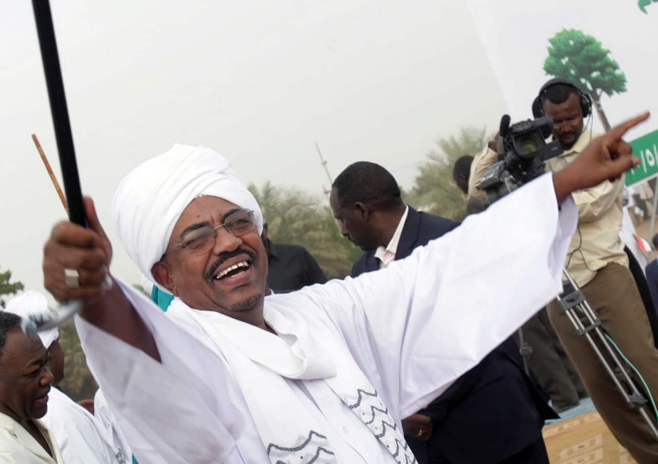 Sudanese President Omar al-Bashir greets his supporters during a rally at a fair in Khartoum, Sudan.