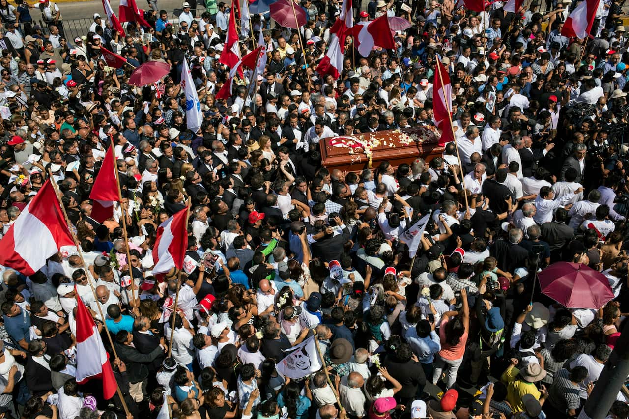 People carry the coffin of Peru's late President Alan Garcia during his funeral procession in Lima, Peru.