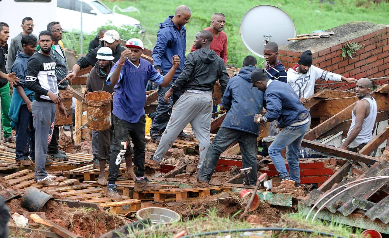Rescue workers search for bodies in a collapsed building near Durban in South Africa.