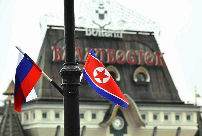 Russia and North Korean flags are seen near Vladivostok station.