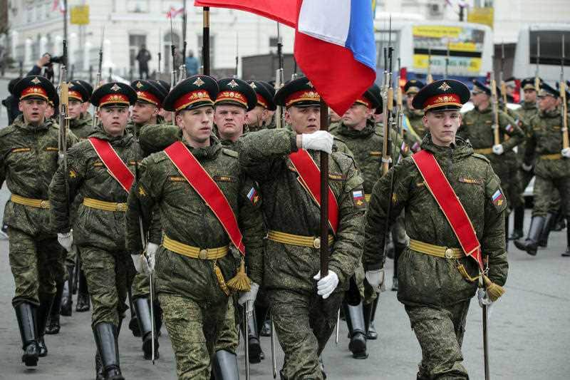 Russian honor guards leave an official welcoming ceremony for the North Korean leader.