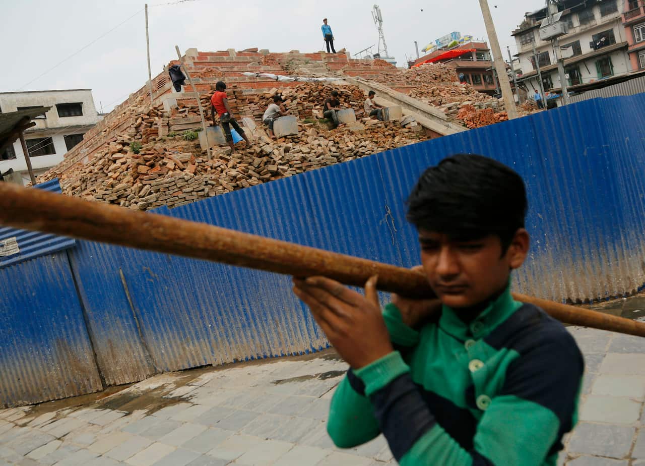 A Nepalese reconstruction laborer works on a reconstruction site in Basantapur Durbar square.