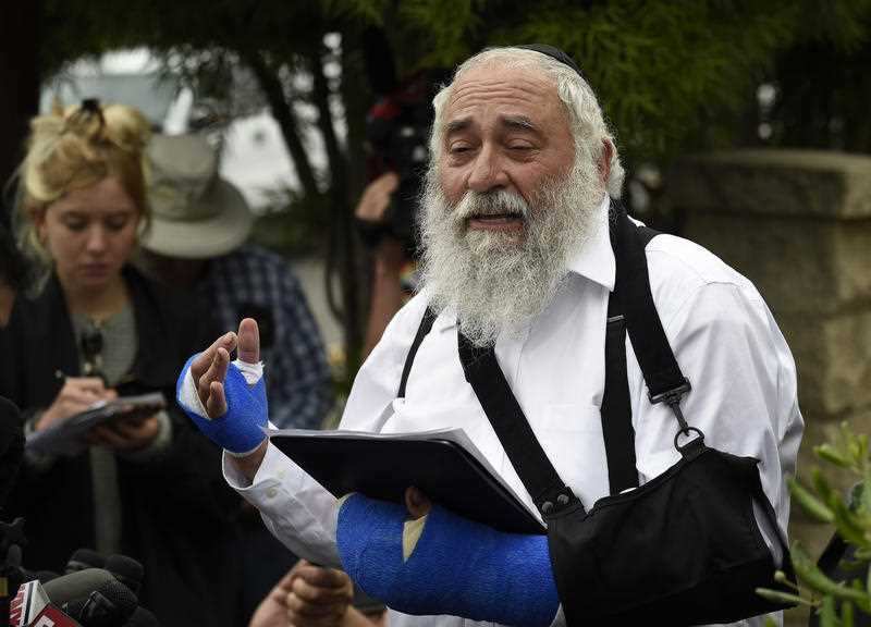 Rabbi Yisroel Goldstein carried on preaching despite being shot at short range mid-sermon. 
