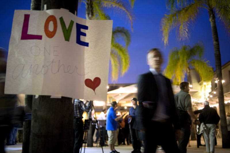 People gather for an evening vigil for the victims of the Poway synagogue shooting.