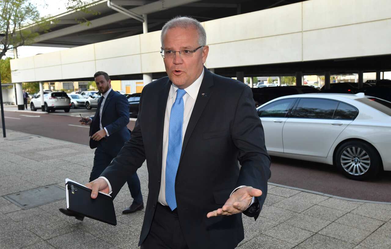Prime Minister Scott Morrison arrives for the first leaders debate of the campaign. 
