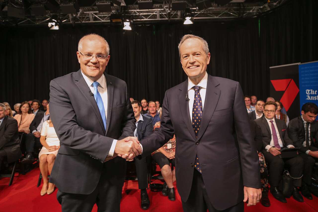 Prime Minister Scott Morrison and Opposition Leader Bill Shorten shake hands before the first leaders debate in Perth. 