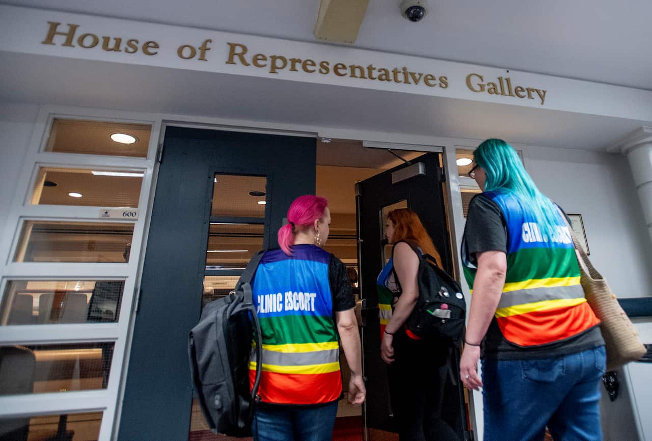 Women's heath clinic escorts walk into the gallery to watch debate on the abortion ban bill.