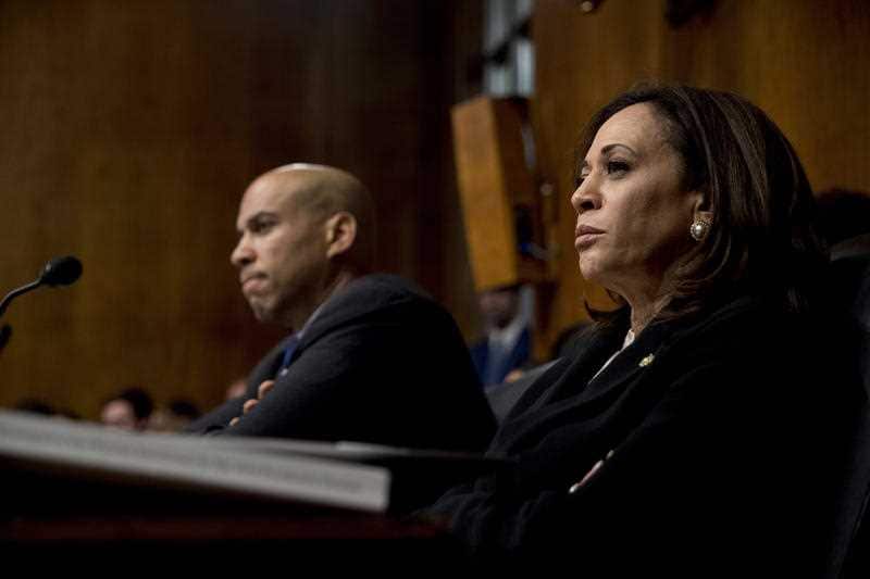 Democratic Sen. Cory Booker and Sen. Kamala Harris listen as Attorney General William Barr testifies during the Senate Judiciary Committee hearing