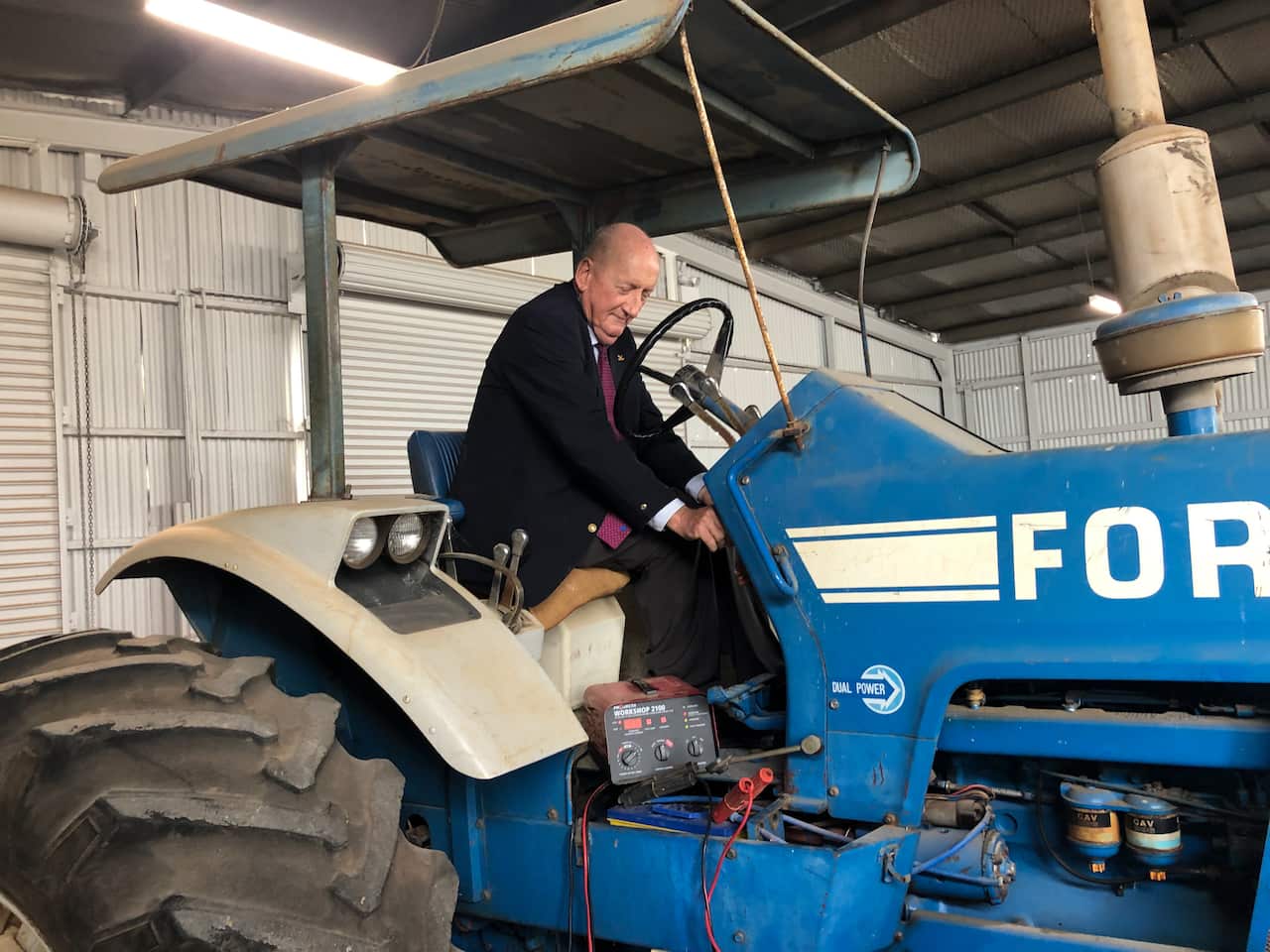 Former Nationals leader Tim Fischer on his first tractor at Gunyah Museum in Lockhart, NSW.