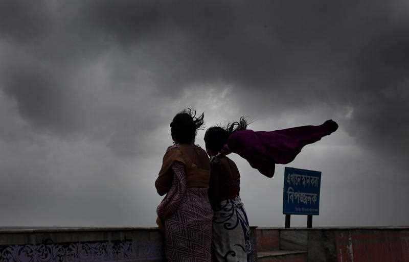 Locals wait as tourists are evacuted before Cyclone Fani made landfall.