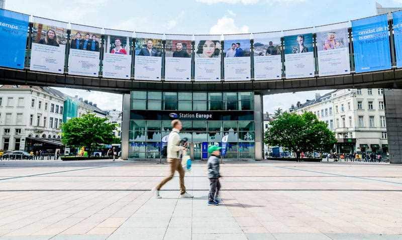 People walk outside the European Parliament in Brussels