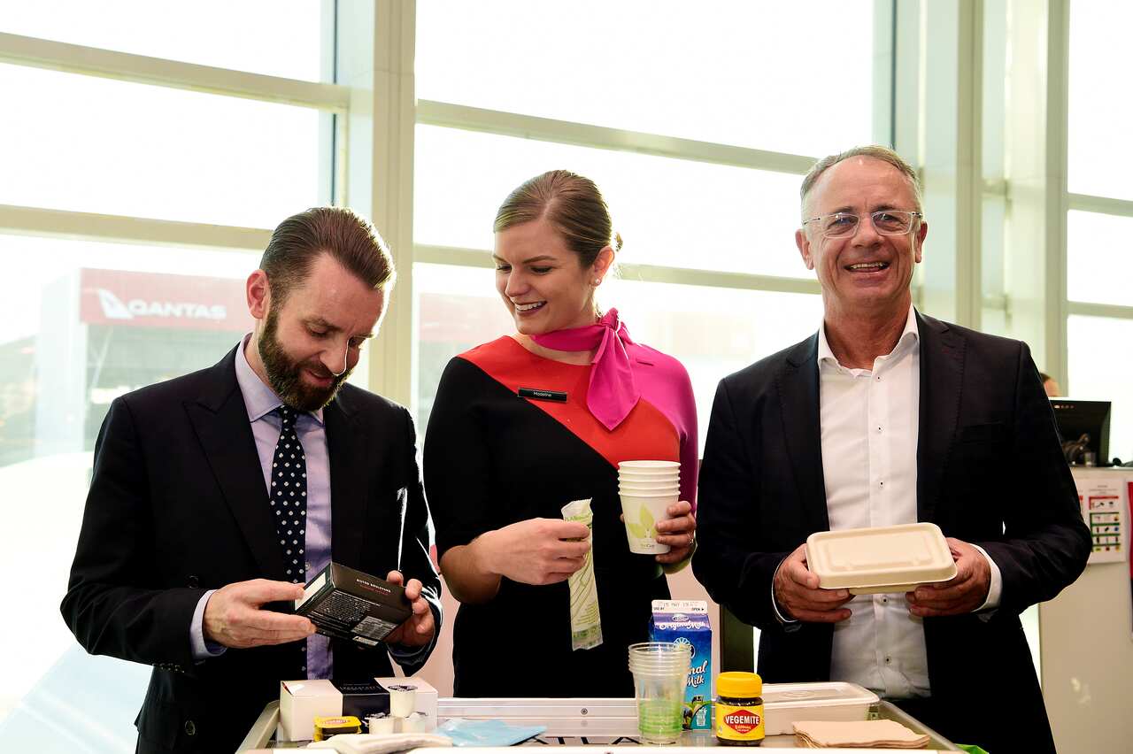 Qantas group executive for sustainability Andrew Parker, left, Qantas flight attendant Madeline Rowcliff and Qantas Domestic CEO Andrew David.