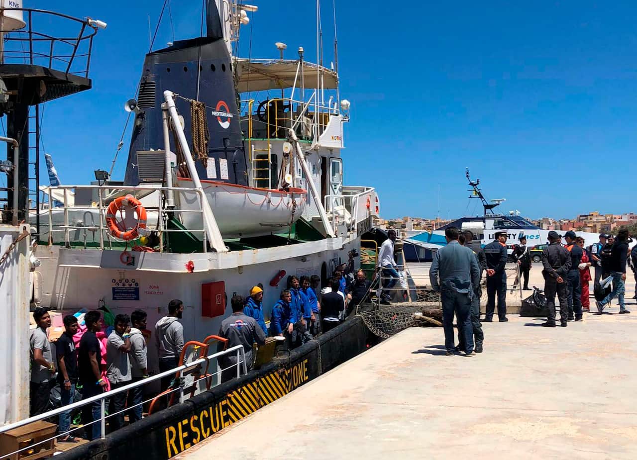 Migrants desembark from the Mare Jonio ship at the dock in the Italian island of Lampedusa island.