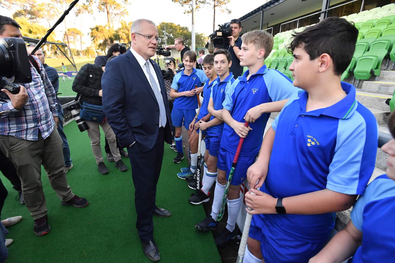 Prime Minister Scott Morrison meets members of the boys hockey team at the Perth Hockey Stadium in Perth, Monday, May 13, 2019. (AAP Image/Mick Tsikas) NO ARCHIVING