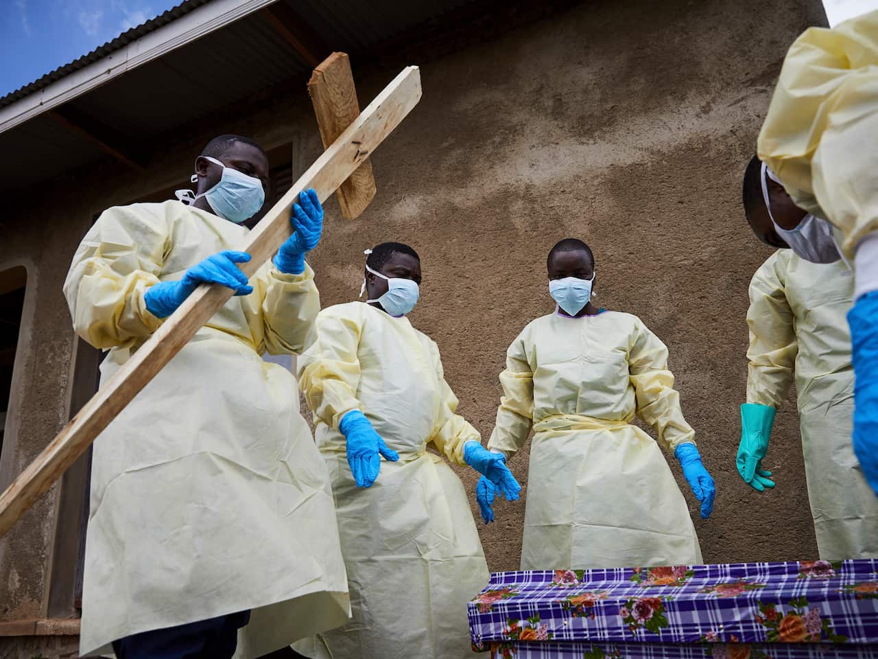 Health workers take part in the funeral of Kahumbu Ngalyakuthi, who got infected after sharing a hospital room with a patient infected with Ebola in DRC