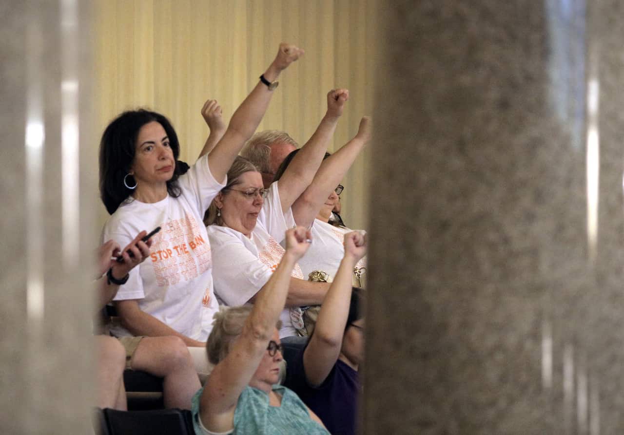 Abortion rights activists seated in the Missouri House react after lawmakers approved the sweeping piece of anti-abortion legislation.