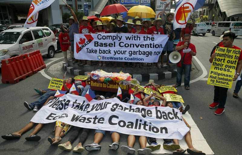 Environmentalists stage a mock die-in protest outside the Canadian Embassy in Manila.