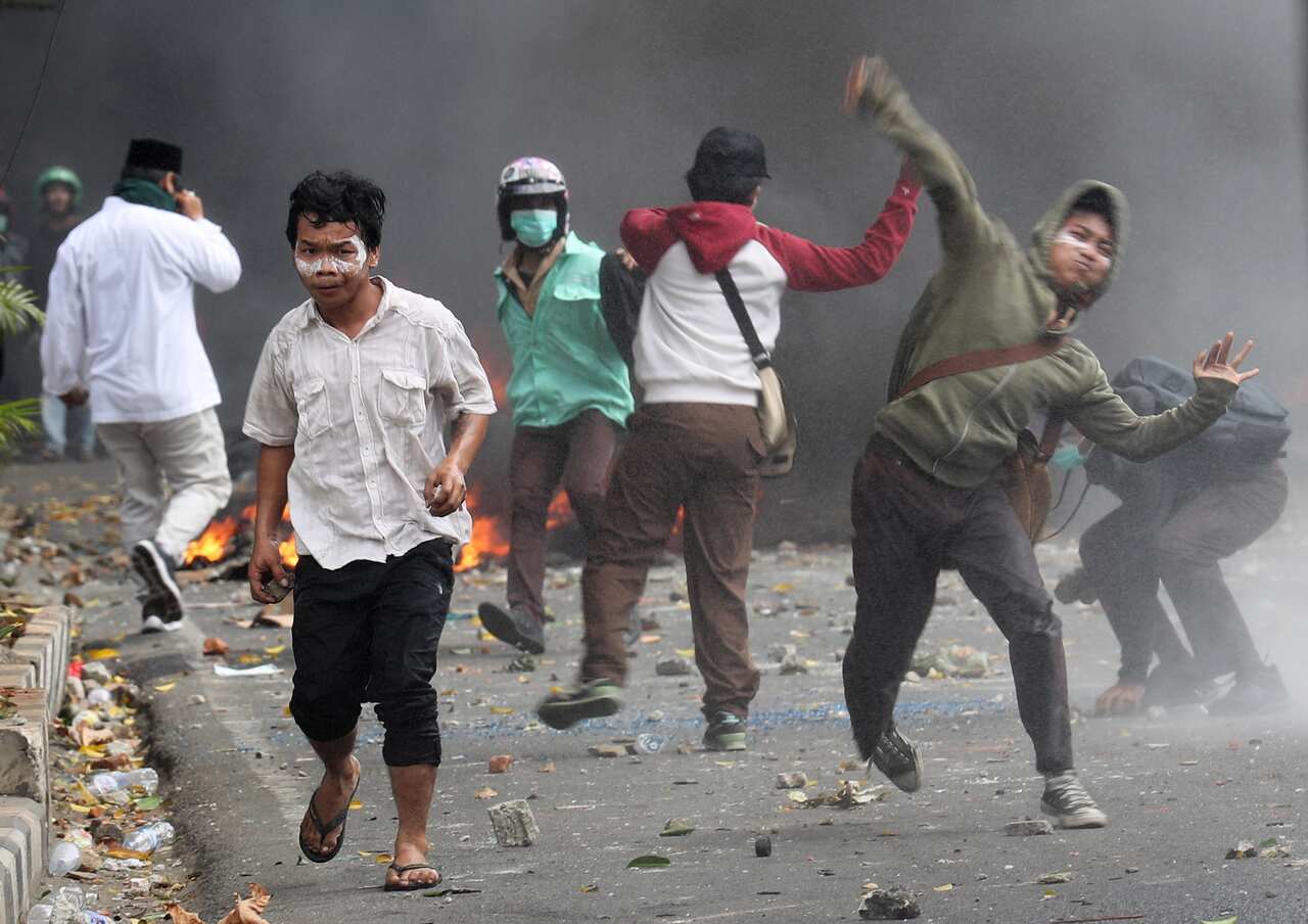 Indonesian protesters clash with riot police officers during a protest following the announcement of the presidential election results in Jakarta.