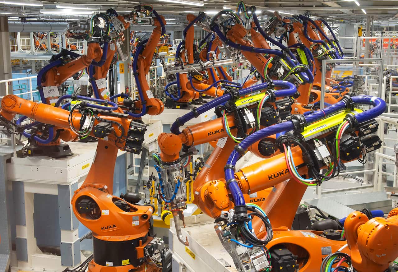 Robots stand at the assembly line for electrical car body construction at the Volkswagen plant in Germany.