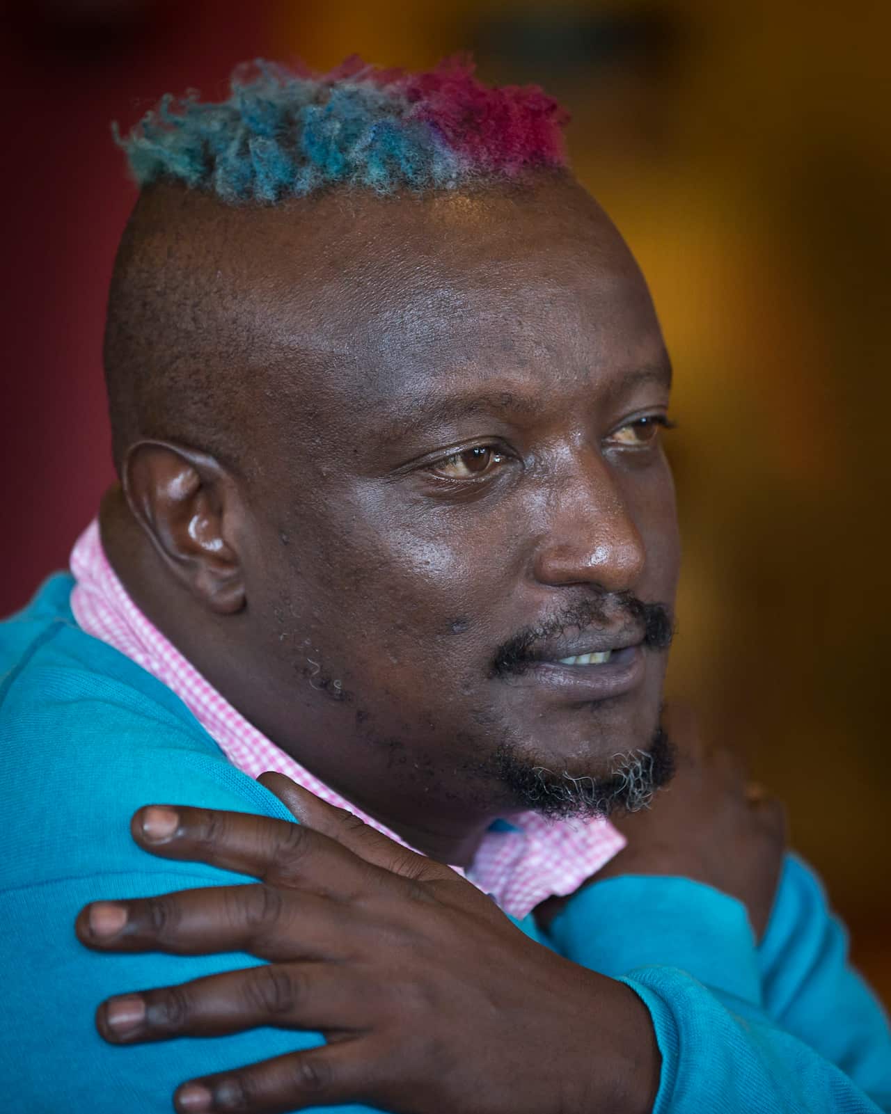 Binyavanga Wainaina talks during a television interview in Nairobi, Kenya.
