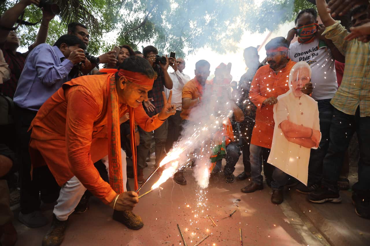 BJP supporters celebrate.