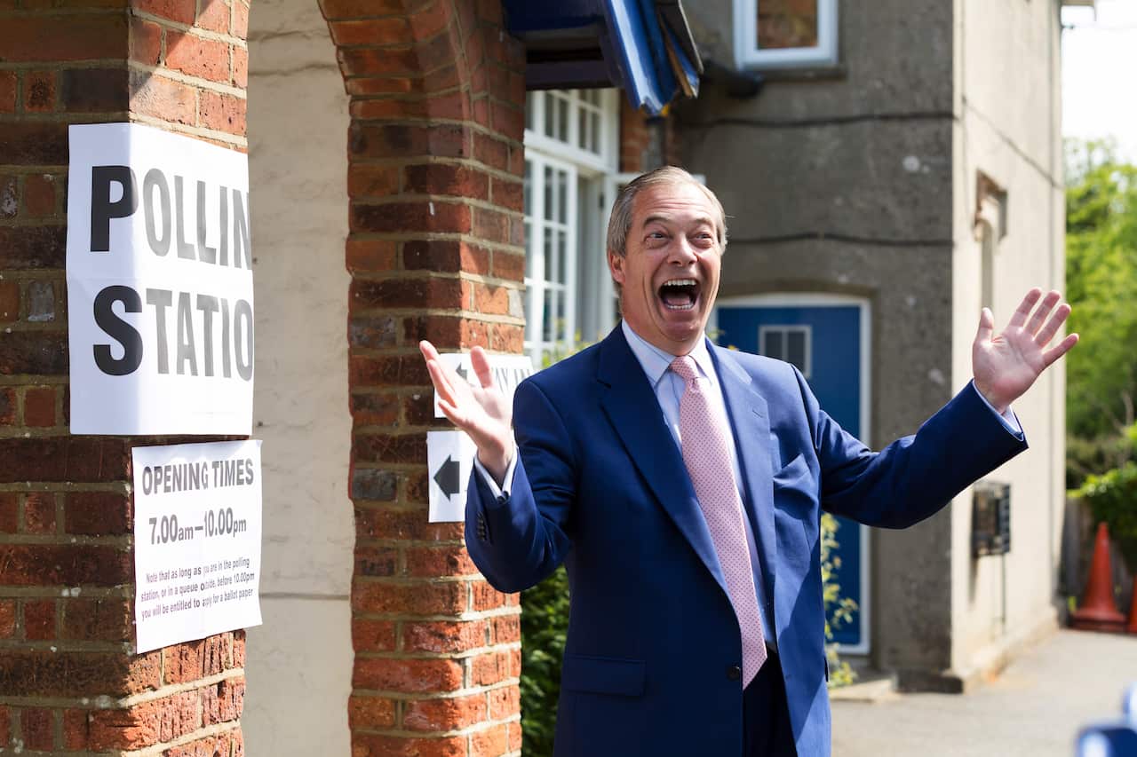 Nigel Farage arrives to cast his vote in the European elections.