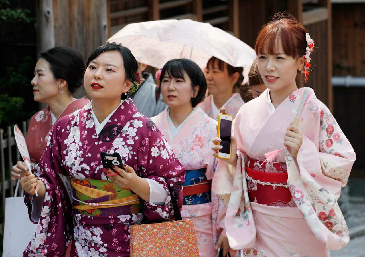 Women wearing kimono walk in Kyoto on May 26, 2019, as a heat wave grips Japan with temperatures exceeding 30 C in many parts of country. (Kyodo via AP Images) ==Kyodo