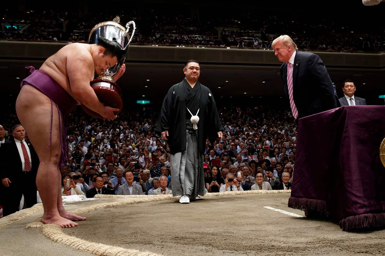 President Donald Trump presents the "President's Cup" the Tokyo Grand Sumo Tournament.