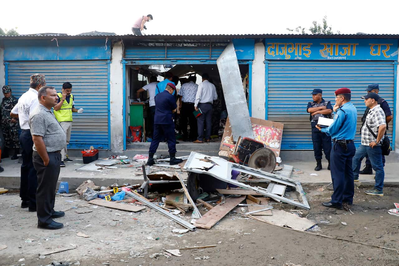 Security personnel checking and seal an explosion site in Kathmandu.