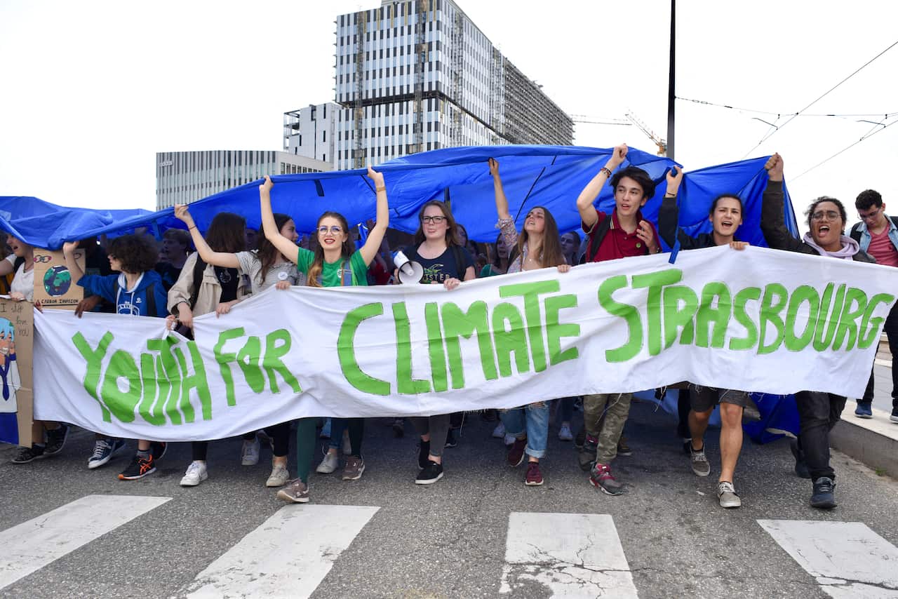Youth gather to draw attention to climate change in front of the European Parliament, the day before the European elections.