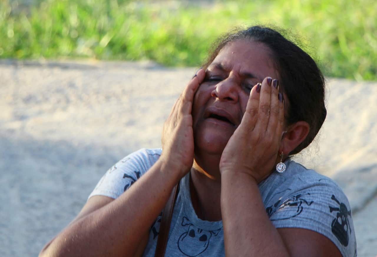 The mother of a prisoner cries as she waits for more information outside the Anisio Jobim Prison after a deadly riot in May.