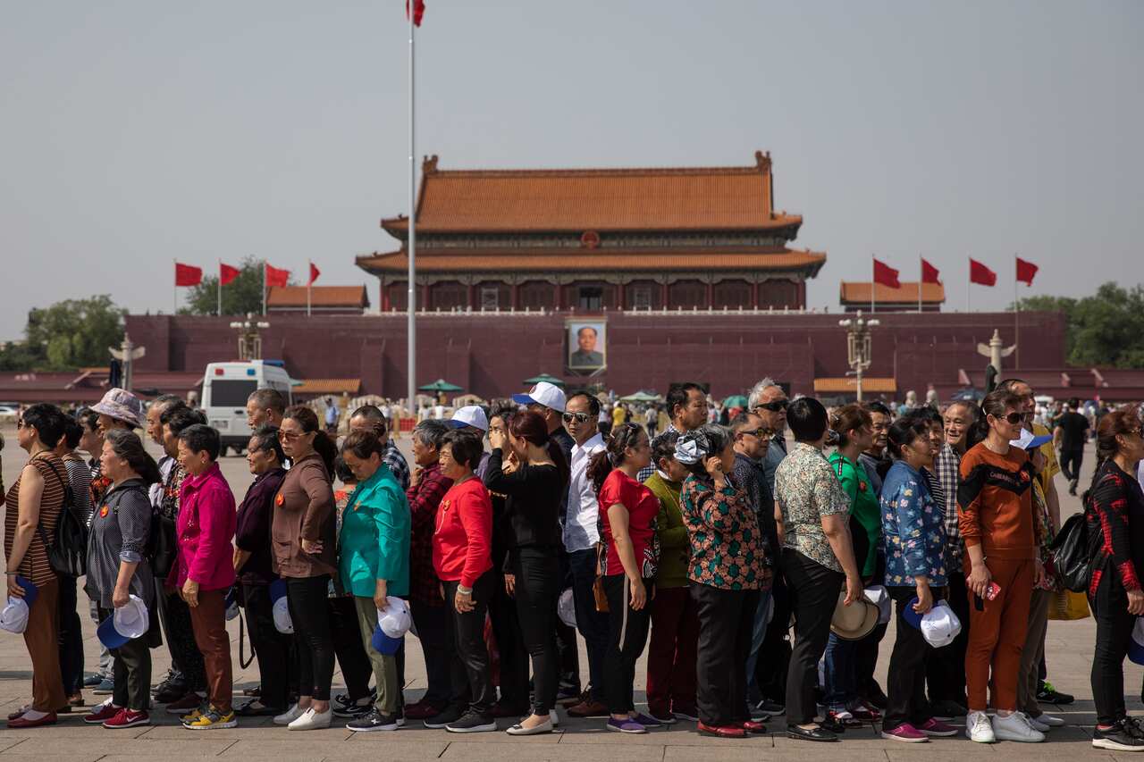 Chinese tourists visit the Tiananmen Square in Beijing.