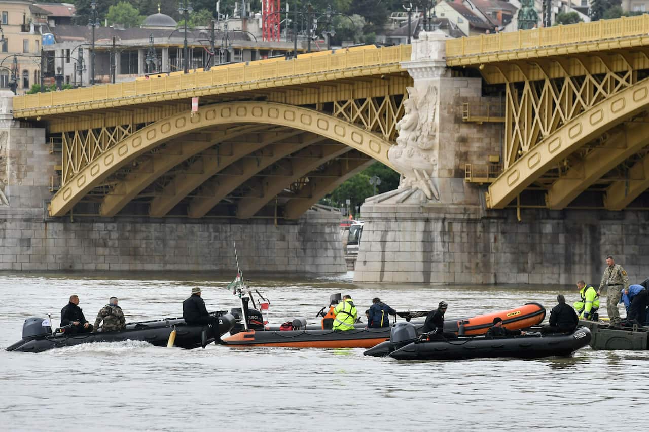 Rescuers prepare to recover the capsized boat under Margaret Bridge in Budapest.